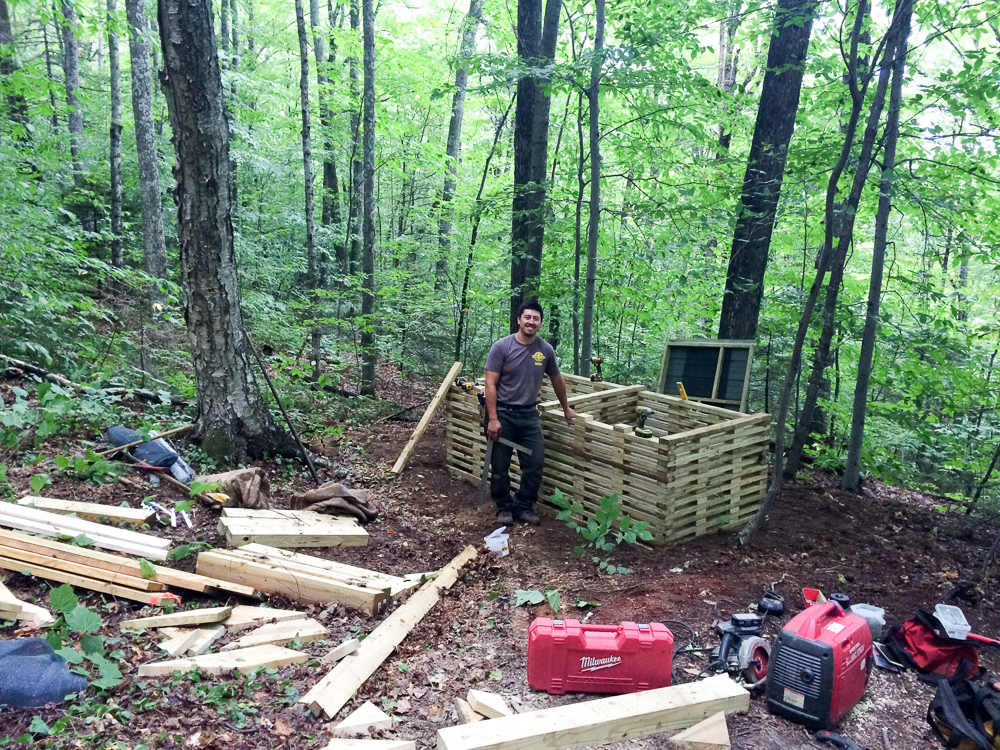 Construction crew building new cribs for the moldering privy at Thistle Hill Shelter