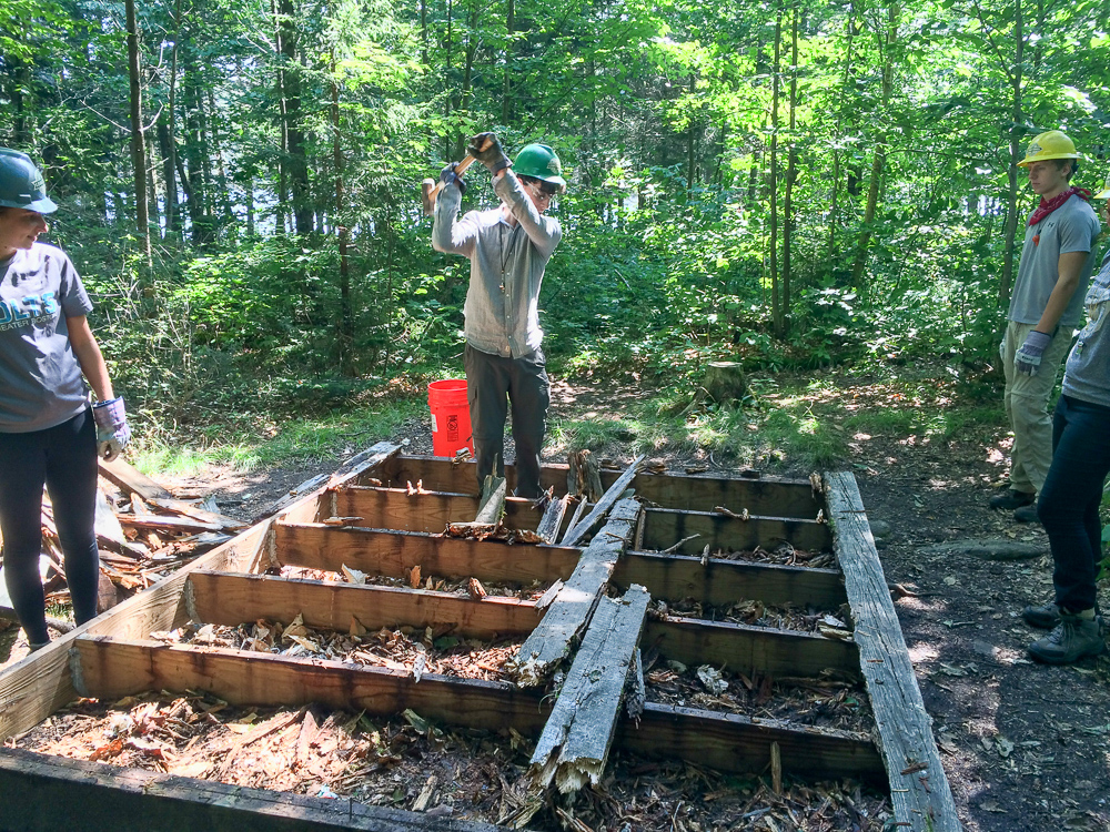 Yale service trip disassembling North Shore tenting platforms at Stratton Pond