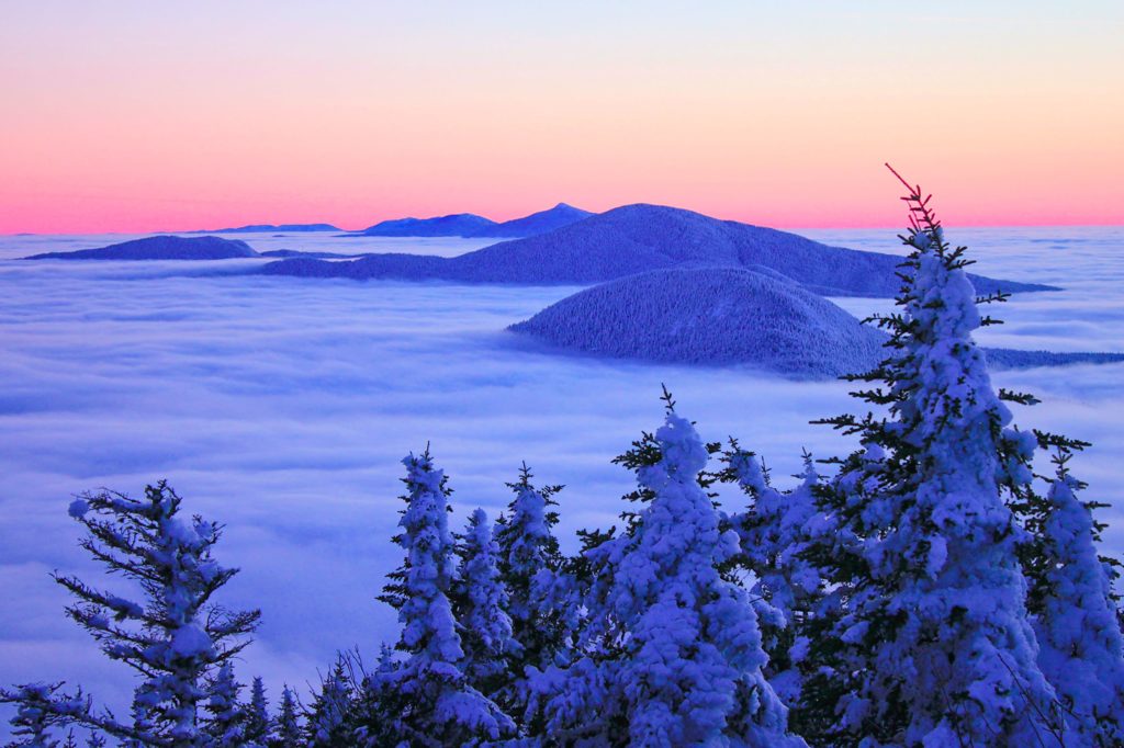 mountains peak above the clouds