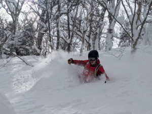 John skis down a snowy slope.