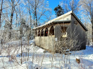 Buchanan Shelter, a wooden, four-walled shelter, in snow