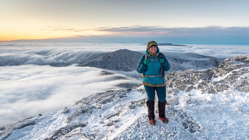 Stephanie stands on Camel's Hump with thick cloud layer below