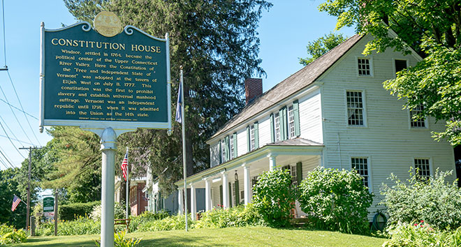 The Constitution House is a white house with green signage marking its historical significance.