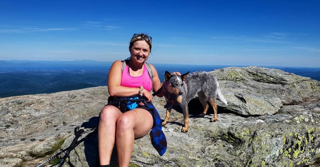 Kristina and Sierra, her blue heeler, on Camel's Hump peaks