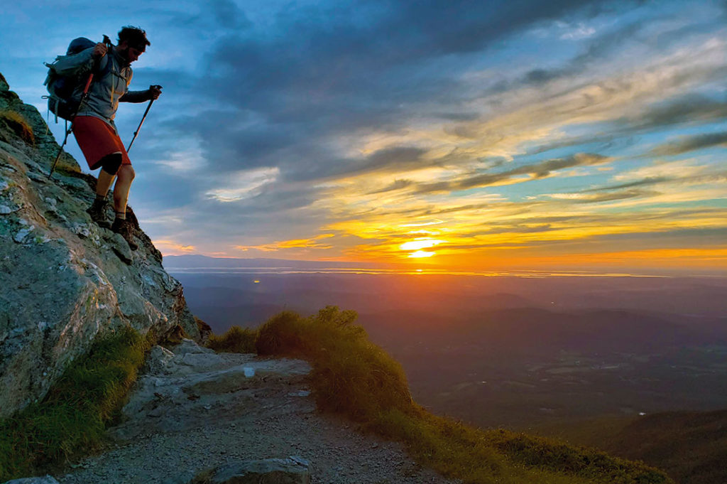 Hiker and sunset on Mt. Mansfield.