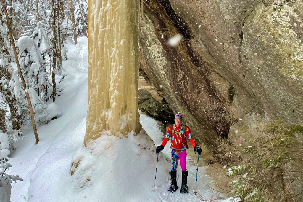 Chris Scott, colorfully dressed, under winter ice on Laraway Mt.