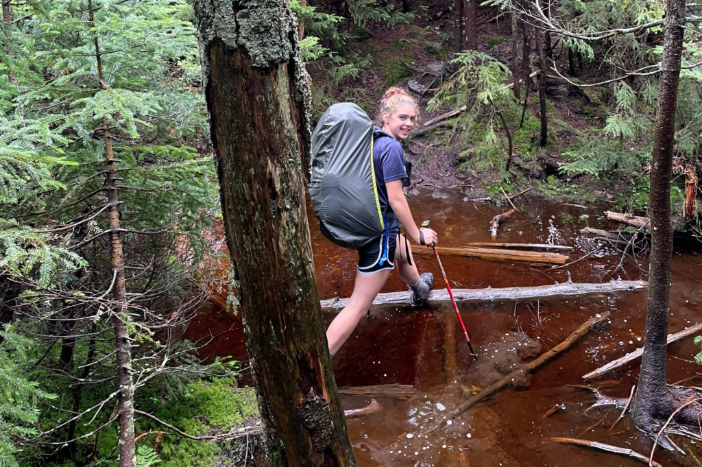 Ruth traverses a waterlogged trail.