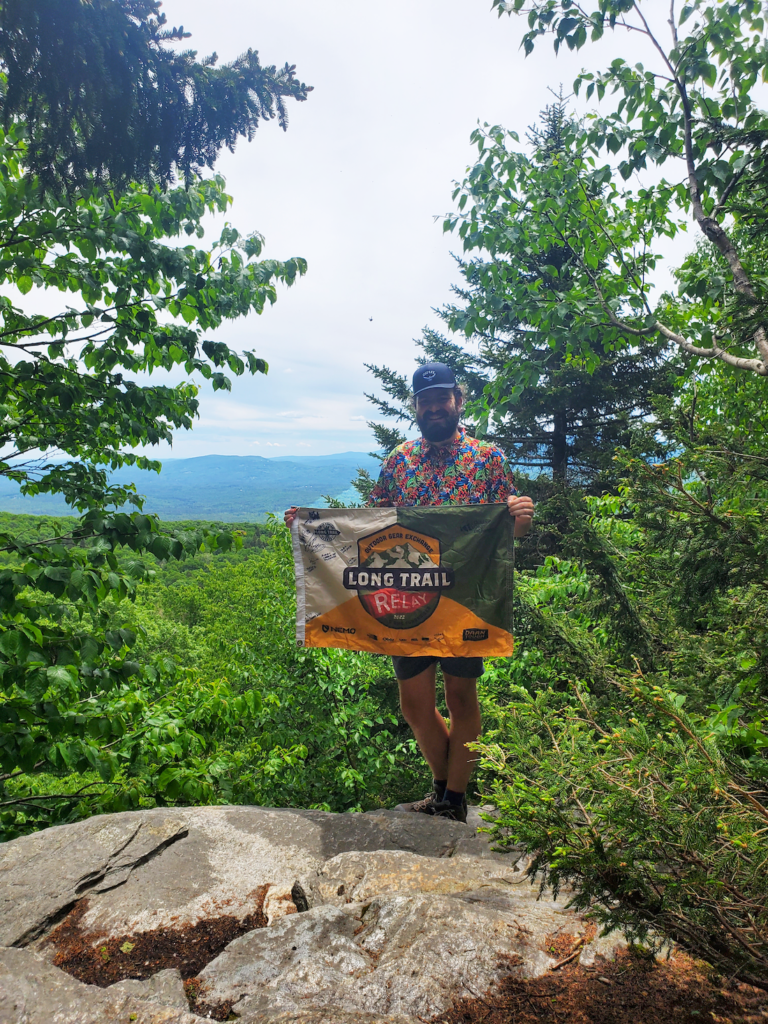 Adam Habel poses with OGE LT Relay flag