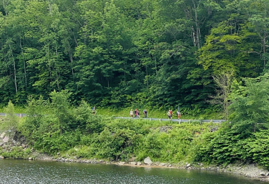 OGE LEadership team approaches the Winooski Footbridge