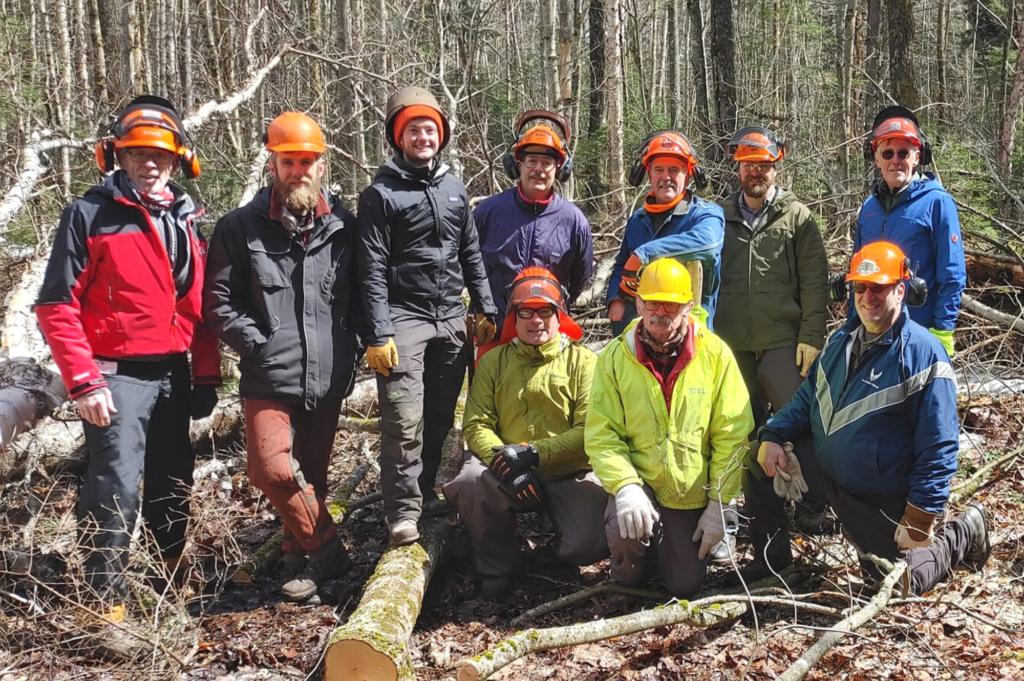 GMC volunteers pose at Grout Pond during sawyer training.