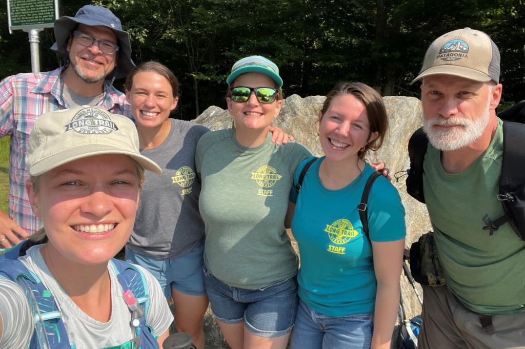 Liz Derstine (left) smiles with hikers and GMC staff before leading a hike up Mt. Mansfield on Long Trail Day 2022.