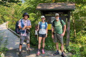 John, Liz, and Mark smile at the trailhead before heading south on the Long Trail.