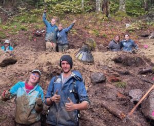 caretakers and trail crew build piers for shelter