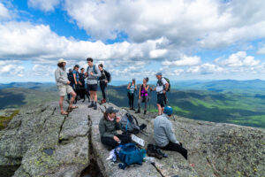 Liam Ebner, Summit Steward for the Adirondack Club, talks with hikers on an alpine summit.