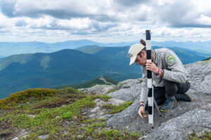 Liam Ebner, Summit Steward for the Adirondack Club, on an alpine summit.