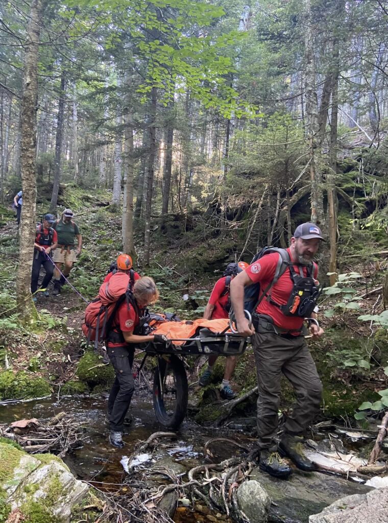 Search and rescue members perform a litter carry on the Long Trail.