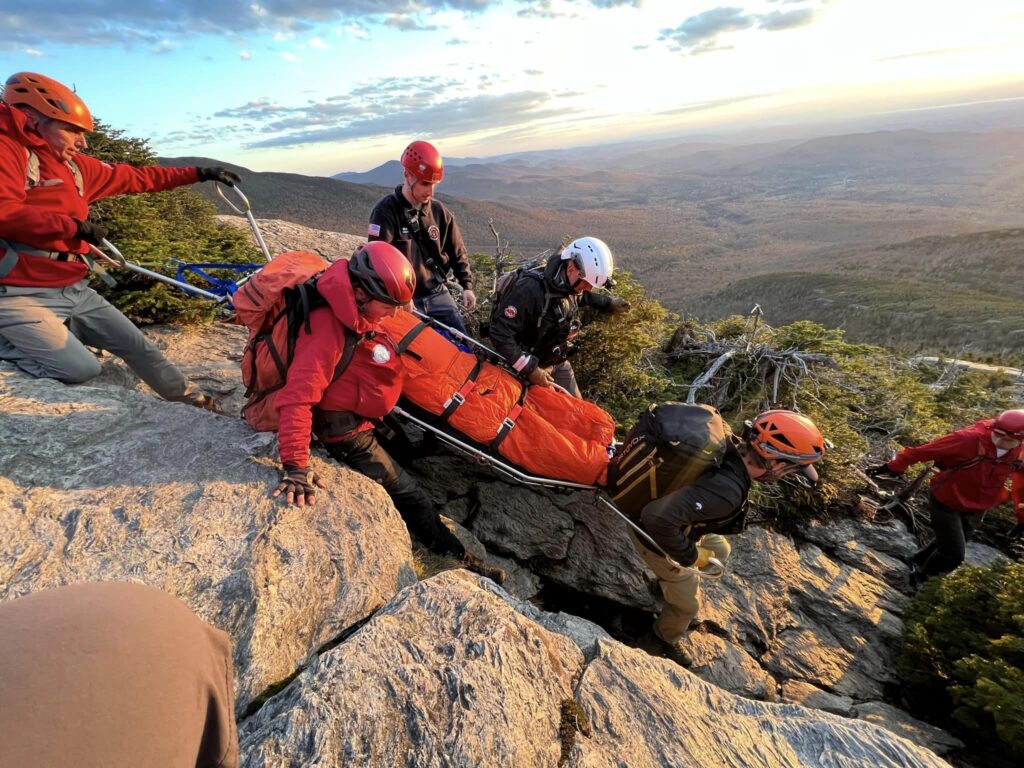 Search and rescue members perform a litter carry down the Sunset Ridge Trail on Mt. Mansfield.