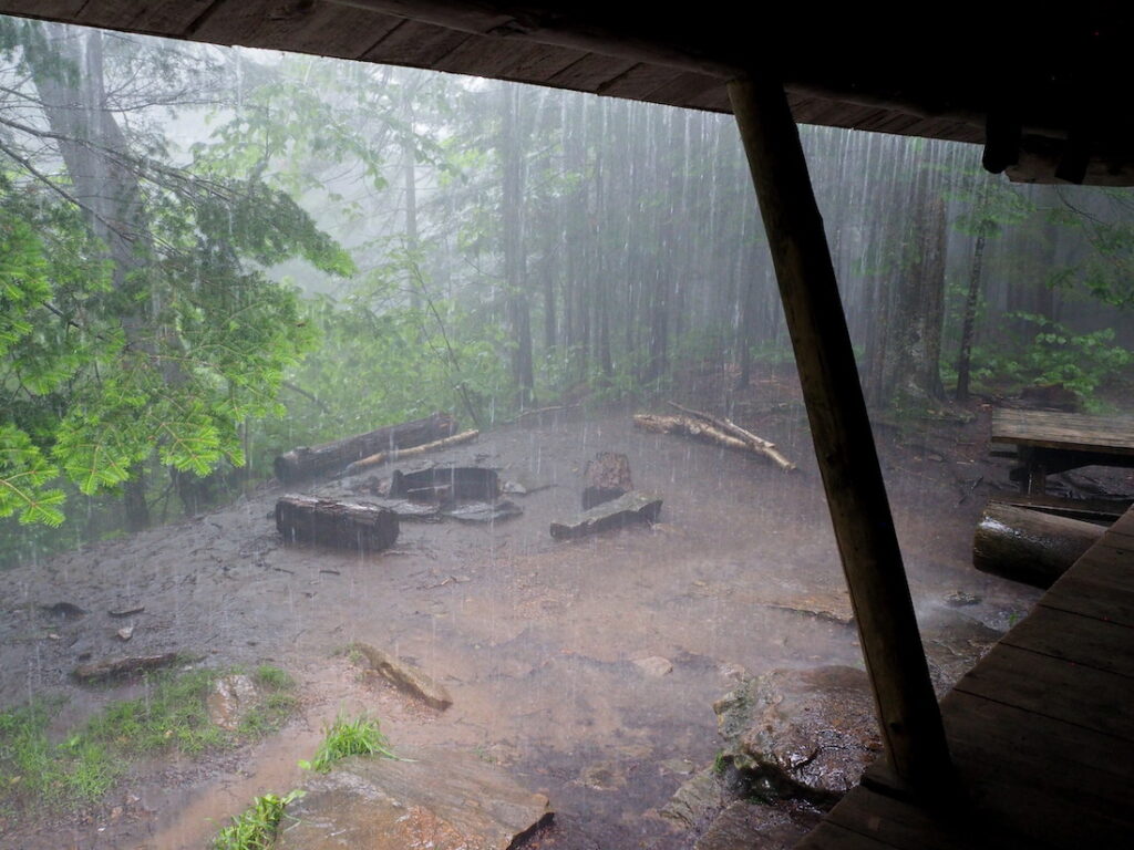 rain pools on the ground around a fire ring