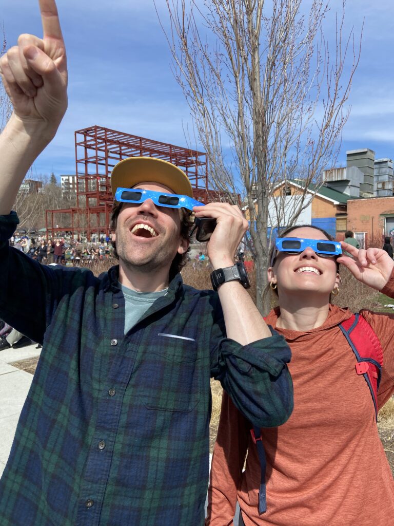 Communications Manager Chloe Miller and her boyfriend Spencer Lewis watch the eclipse in Vermont through their eclipse glasses