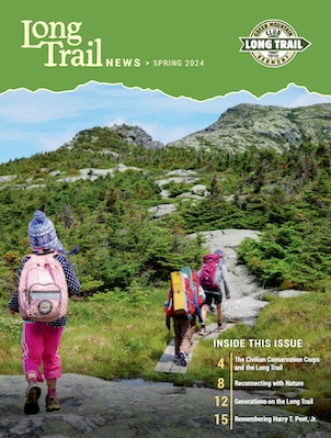 cover of the spring long trail news, features kids hiking with their backs to the camera