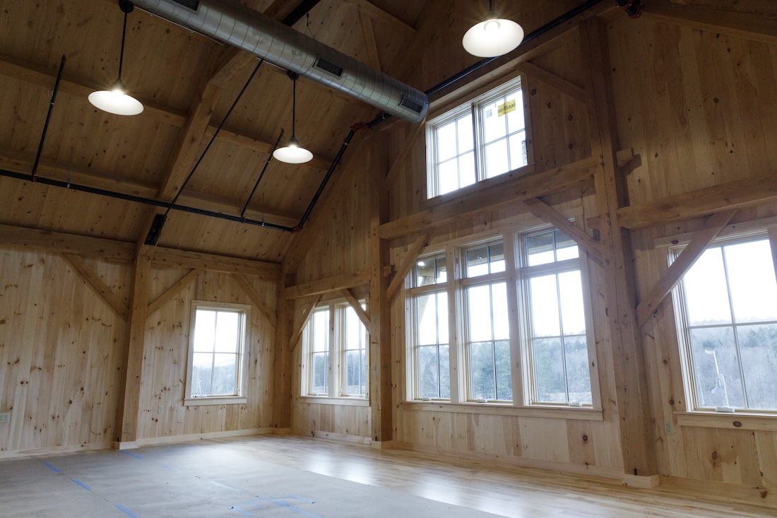 interior of a wood-paneled buildingw ith large bright windows