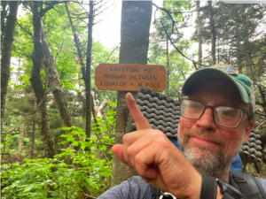 david mcnally, hiker, takes a selfie with a trail sign