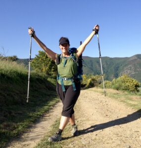 delia clark hiker with hiking poles strikes a pose on a dirt road